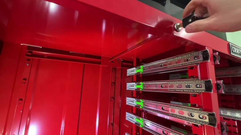 Demonstrating the locking feature of a Craftsman tool cabinet.
