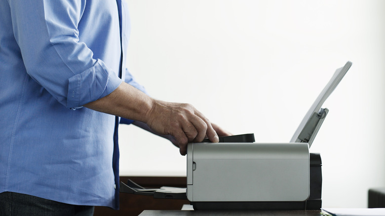 Man fixing a printer