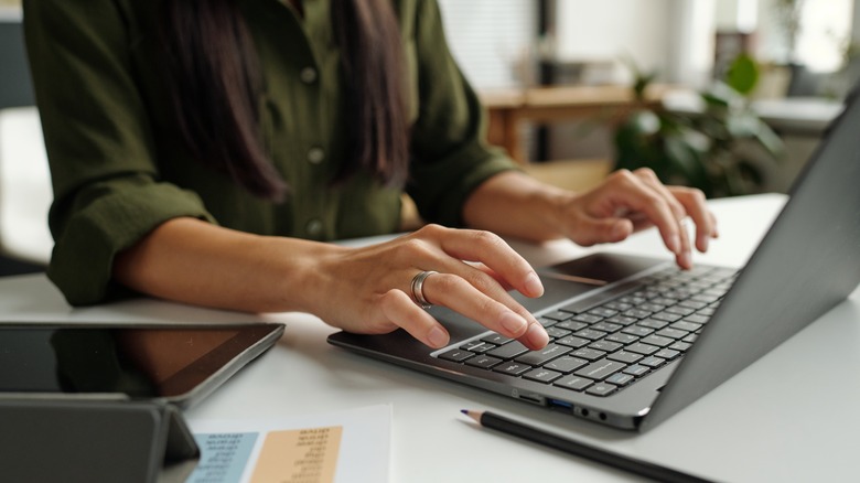 person typing on laptop