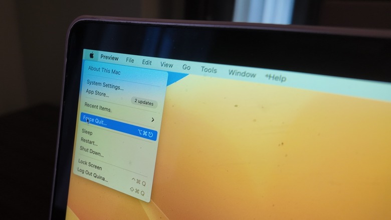 Mac with Apple menu open