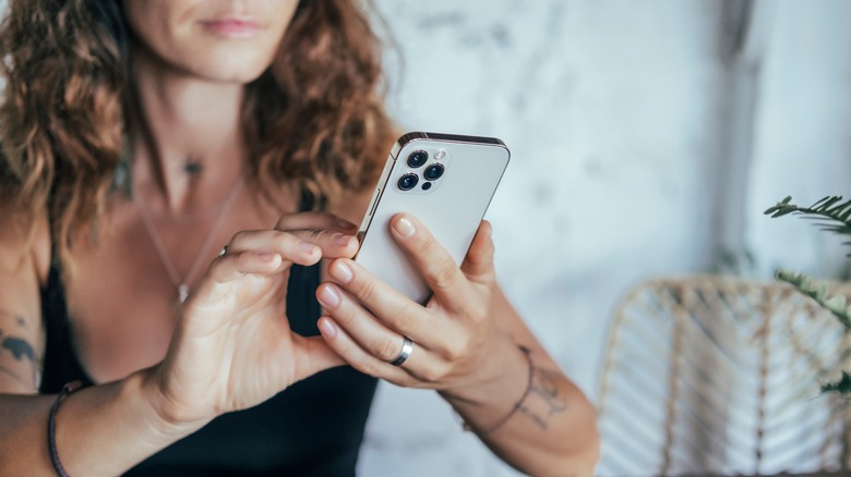 woman using an iphone 14