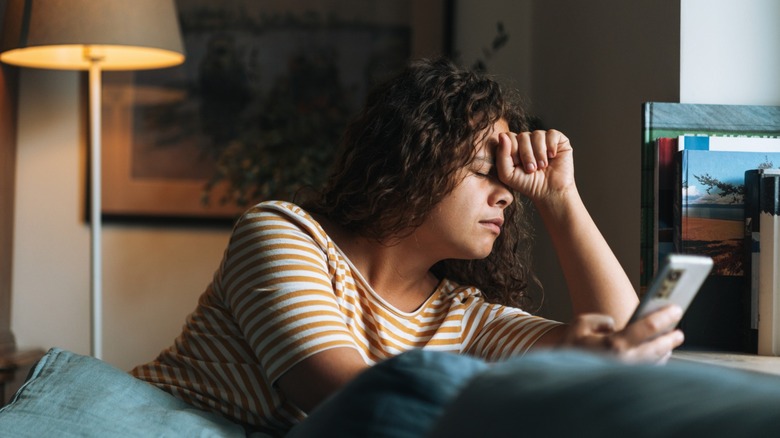 Frustrated woman using her phone