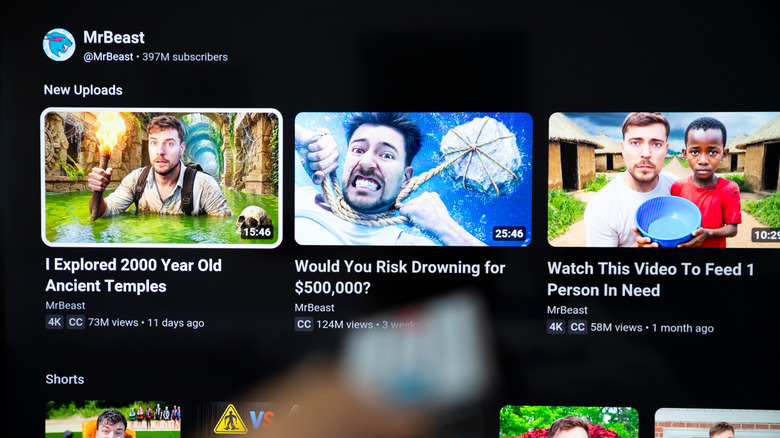 A man watching MrBeast's YouTube channel on his smart TV.