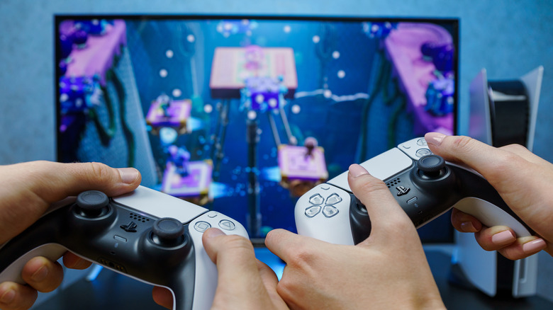 Two people playing PS5