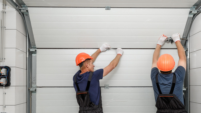 people working on a garage door
