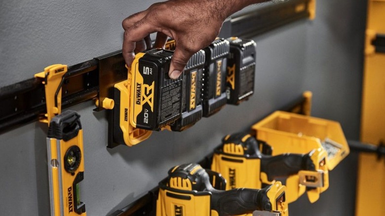 Person removing DeWalt battery from charger