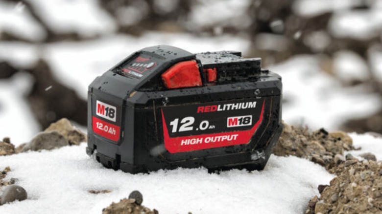 Milwaukee battery sitting on snowy rock
