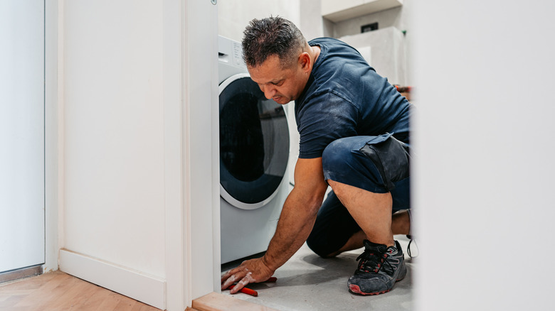 Man working on washing machine