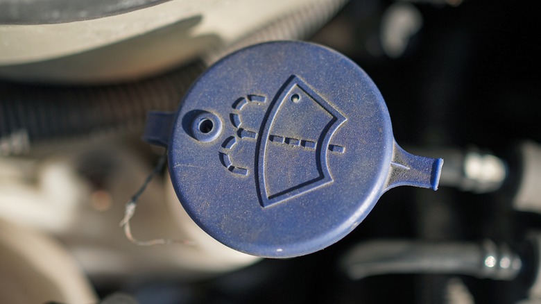 The cap of a windshield wiper fluid reservoir
