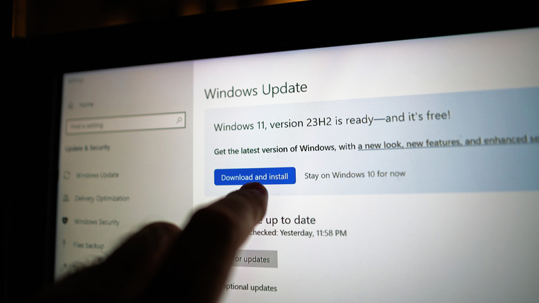 A finger pointing at the latest update available on a Windows computer