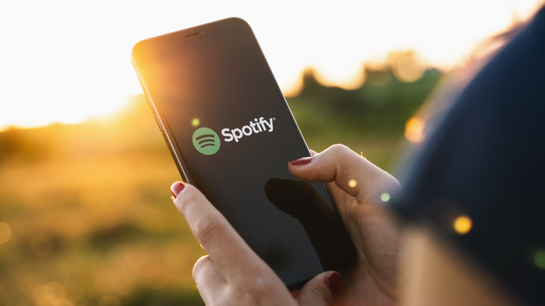woman opening Spotify on a smartphone