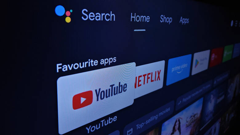 A TV screen showing thumbnails on the home Google TV home screen