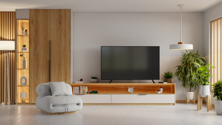 A TV kept on a wooden table in a living room