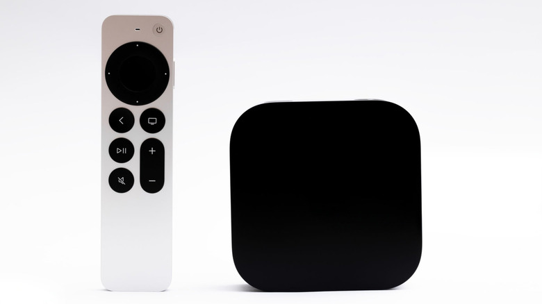An Apple TV box along with its remote