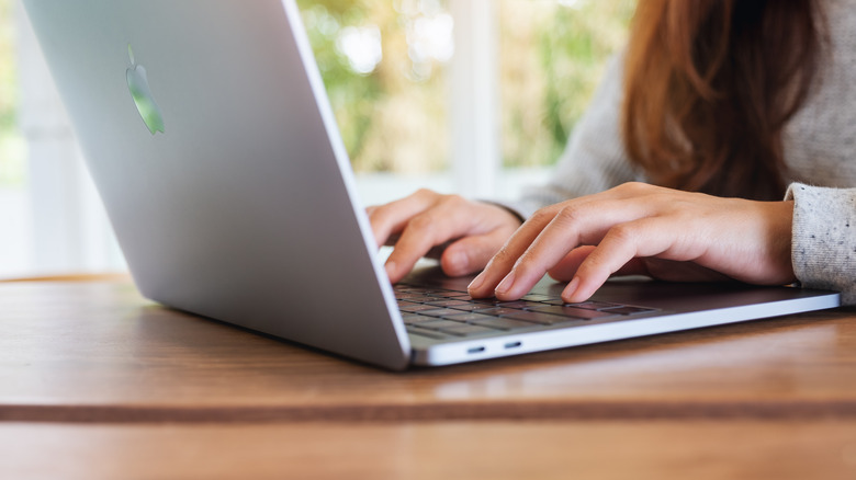 Person typing on Macbook