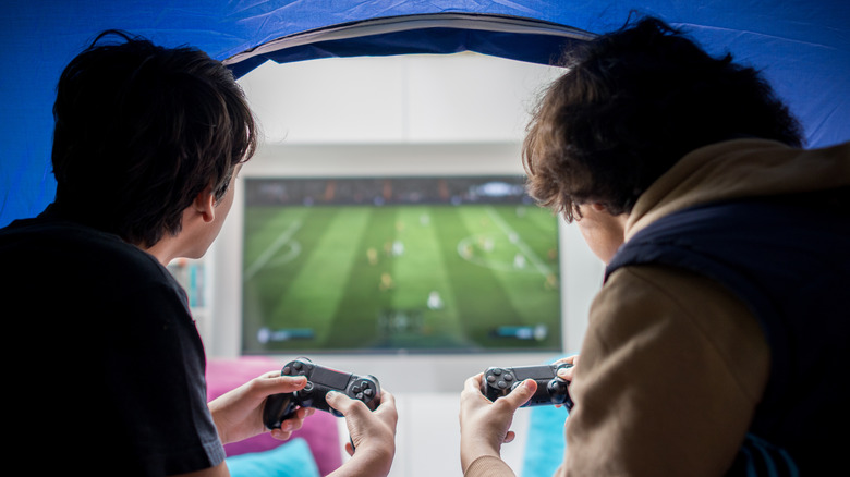 People playing video games inside tent