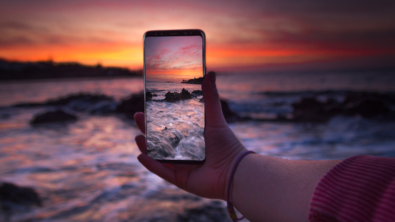 Samsung phone taking photo sunset