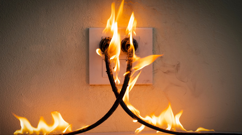 power cords plugged into wall outlet, on fire
