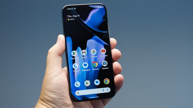 Hand holding an Android phone over a blue background