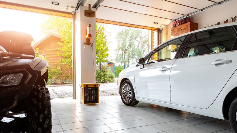 two garage doors and vehicles