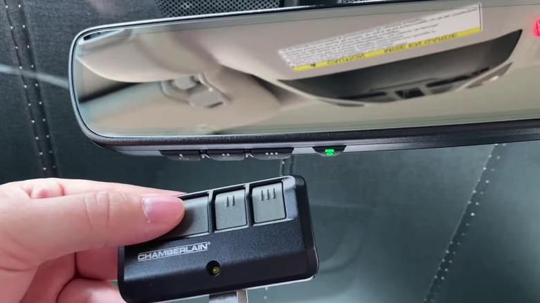 Woman holding garage door remote preparing to program HomeLink