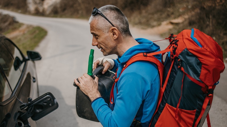 man smelling gas canister