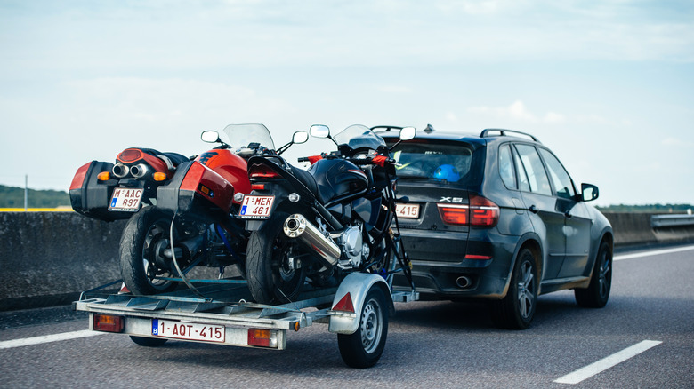 BMW X5 SUV pulling a motocycle trailer
