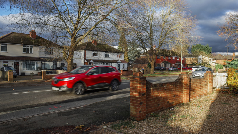 Cars driving in a suburban neighborhood