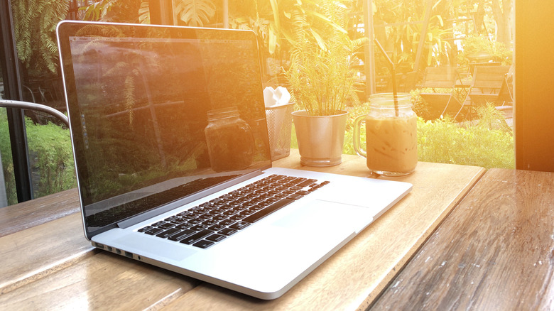 MacBook on a table out in the sunlight