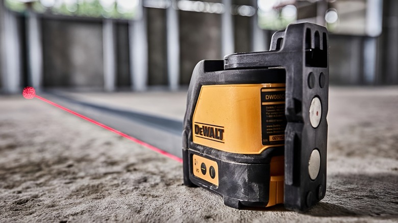 DeWalt laser level emitting red laser across floor