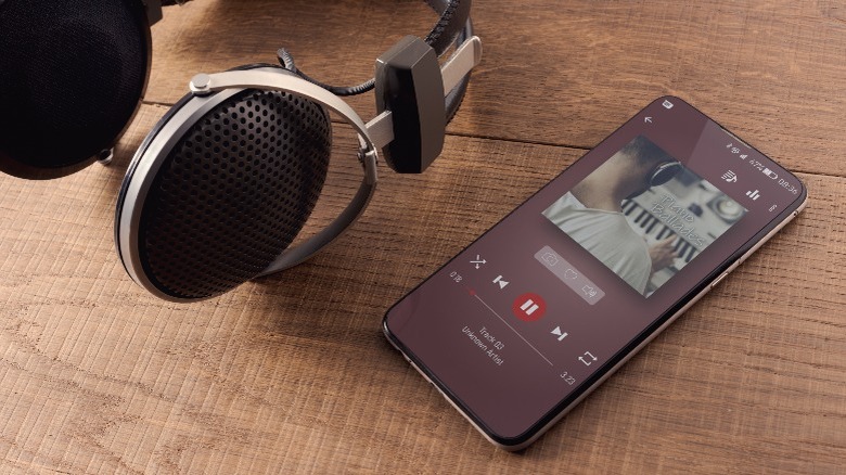 Headphones and smartphone playing music