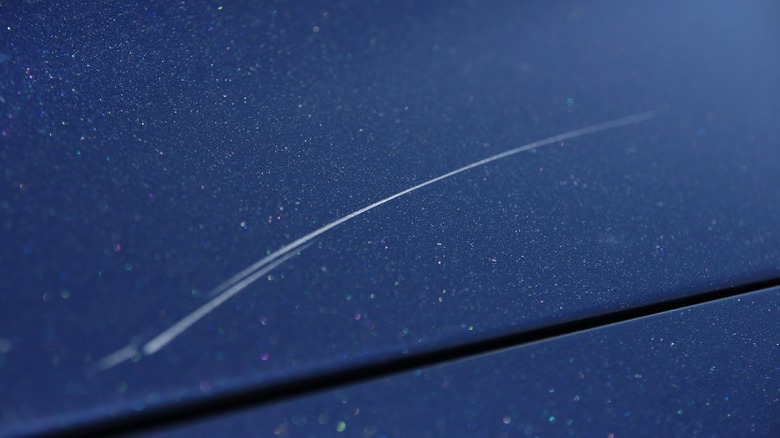 a scratch on a dark colored car