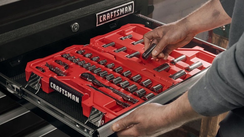 Person taking socket from Craftsman tool chest