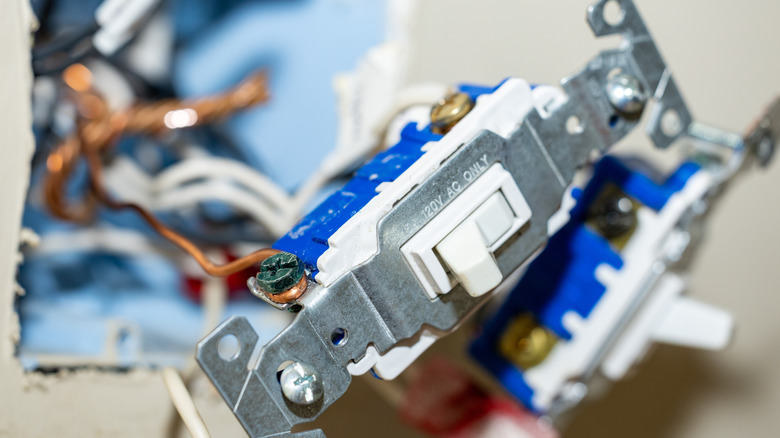 A close up shot of light switches being wired