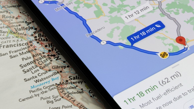person using Google Maps in car