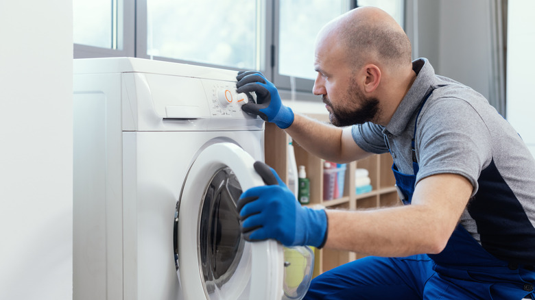 Professional technician checking a washing machine