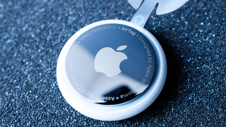 An AirTag's stainless steel cover with Apple logo