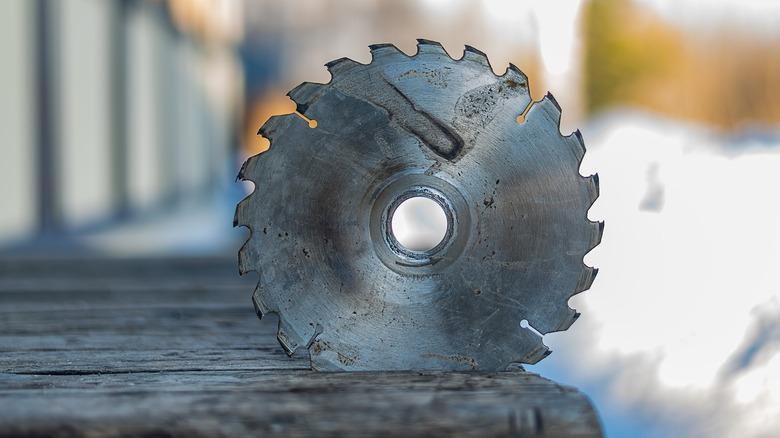 Table saw blade lodged into a piece of wood