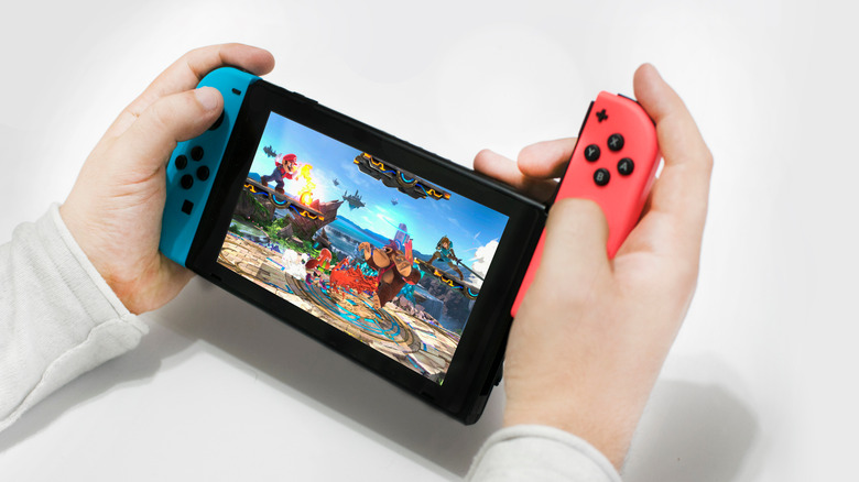 Hand holding Switch Joy-cons