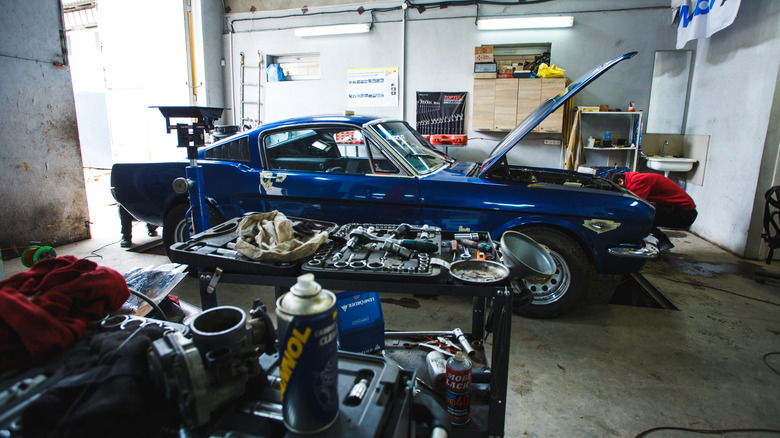 old blue mustang in garage