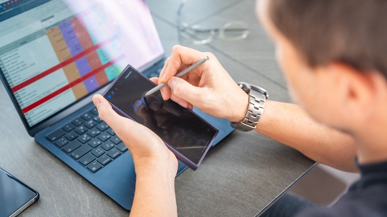 Person using a stylus on a smartphone