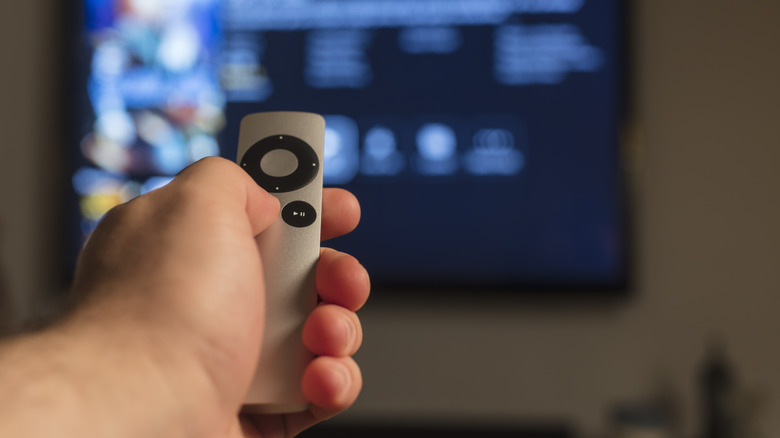 Someone using Apple TV remote