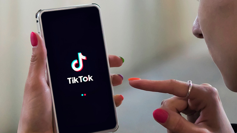 woman using tiktok on phone