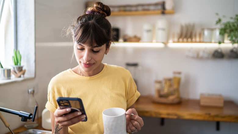 Woman using an iPhone smiling