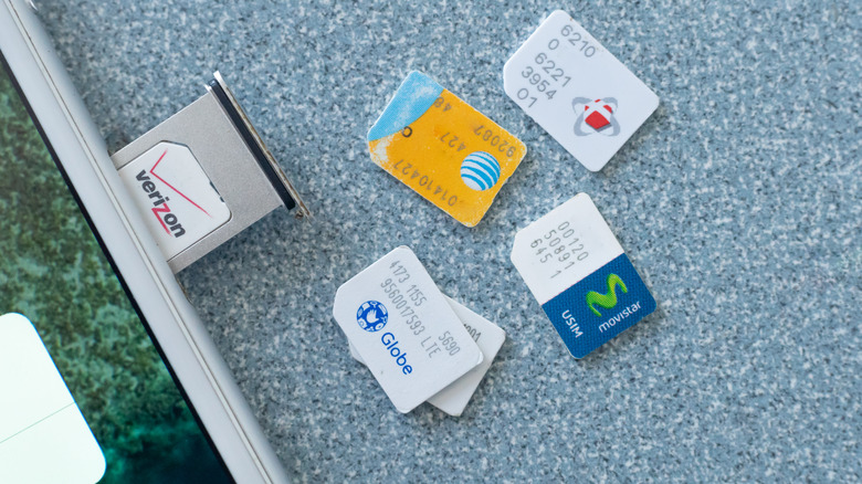 Smartphone next to various sim cards