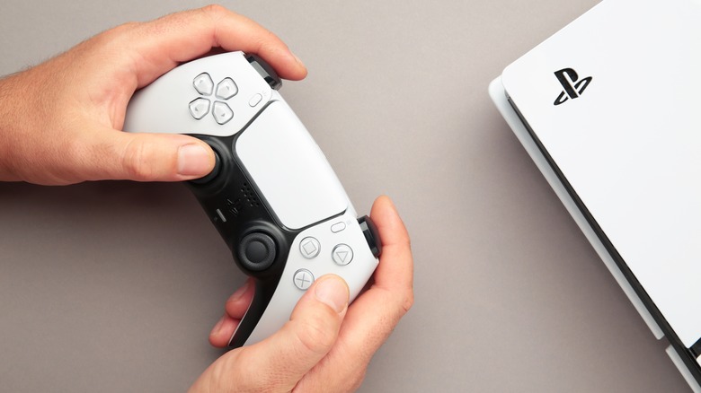 person holding ps5 controller