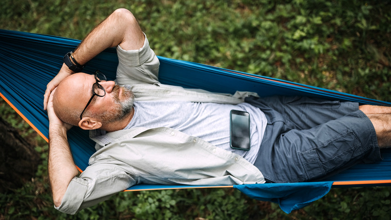 relaxing in hammock with smartphone