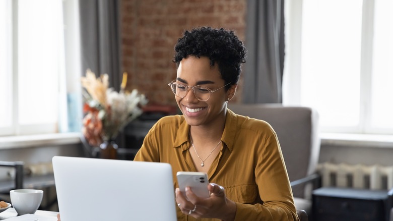 woman on laptop with mobile