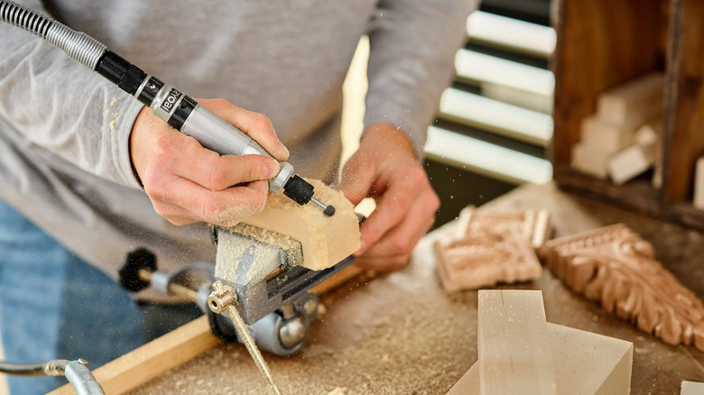 person woodworking using rotary tool