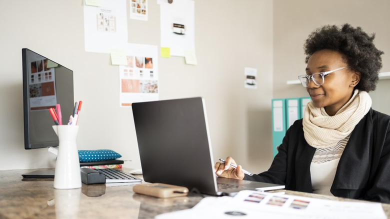 woman working on a laptop at her desk